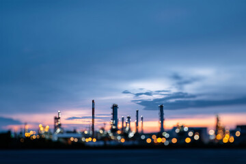 Naklejka premium Industrial skyline illuminated at dusk with soft bokeh effect