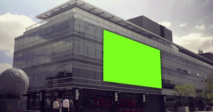 Modern Building With Large Green Screen Billboard For Advertising.