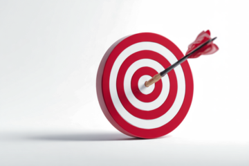 Arrow hitting the bullseye of a red and white target.