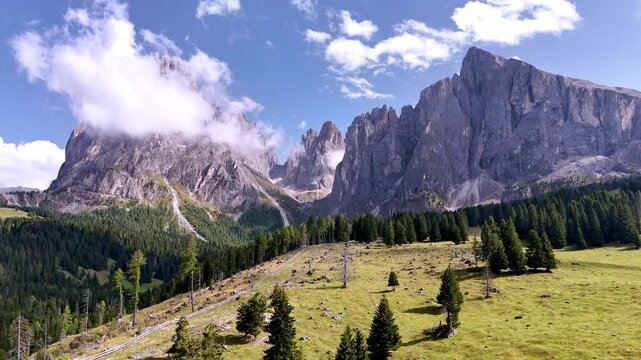 Aerial view of Langkofel mountain in Dolomites, Italy. The top of a mountain Plattkofel Sassopiatto. Dolomites mountain ridge. Seiser Alm Alpe di Siusi aerial view at Summer. Travel in Italy.