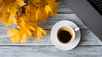 Cozy autumn workspace with coffee and laptop surrounded by vibrant fall leaves