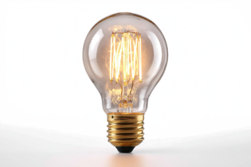 A vintage Edison-style incandescent light bulb with a glowing filament, casting a warm light on a white background.
