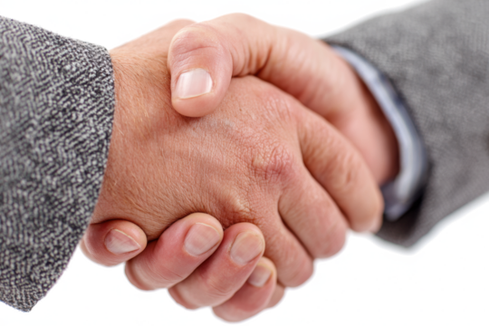 Close-up of two hands clasped in a handshake, symbolizing agreement and cooperation.