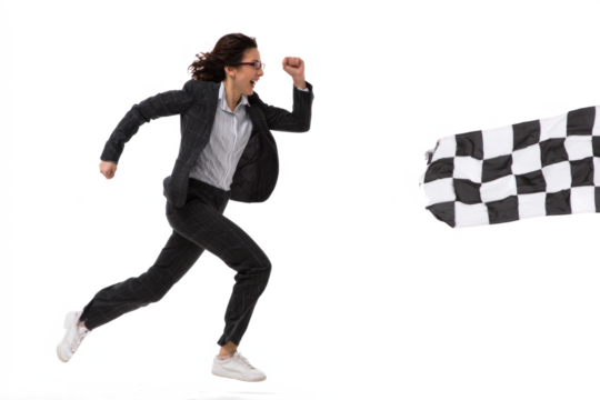 Businesswoman running towards a checkered flag, symbolizing success.