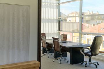 Modern Office Interior with Wooden Furniture, Conference Table, and Computers