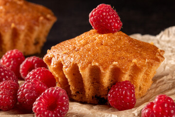 Lemon muffins surrounded by juicy raspberries on a cozy kitchen table scene