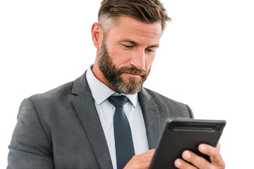 A focused businessman in a suit and tie intently looking at a tablet device.