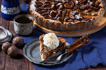 German plum cake with cinnamon, served with ice cream and coffee.