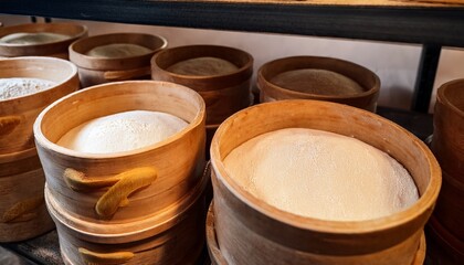 Close Up Of Sourdough Fermenting In Containers In Bakery