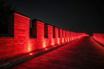 Red illuminated Great Wall structure at night