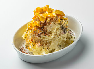 Creamy Japanese Potato Salad Poteto Sarada Topped with Sliced Boiled Egg and Seasoning in white oval bowl on white background side view