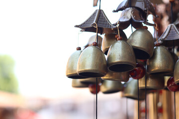Souvenirs in the form of hanging golden bells, close-up. Souvenir market. Hanging bells used for home decoration. Group of bells with selective focus