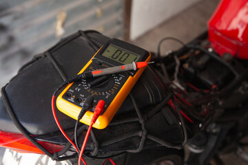 Digital multimeter on a motorcycle, closeup of photo with selective focus