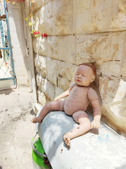 Eerie Doll Resting Against a Stone Wall
