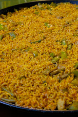 Fideuà cooking in a large traditional paella pan