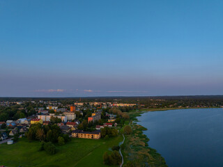 Aerial view of Võru, Estonia at sunset, featuring the serene Tamula Lake and surrounding townscape. Perfect for nature, travel, or cityscape themes with peaceful, scenic countryside vibes.