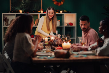 Woman serving thanksgiving turkey to friends and family