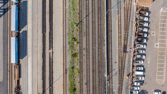 Straight down aerial view of several, many, parallel railroad tracks in a rail yard.