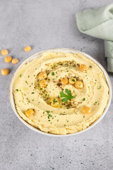 Lupini bean hummus or turmeric hummus with olive oil and herbs on a gray background. Healthy vegan concept.