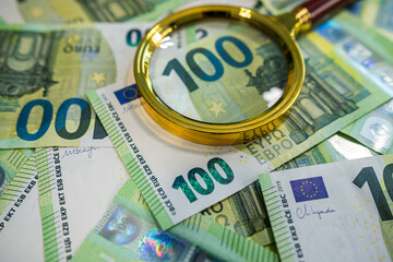 Magnifying Glass Over Euro Banknotes – Close-Up of 100 Euro Bills, Finance and Money Concept