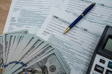 Financial planning essentials: calculator, tax forms, and money for smart decisions.