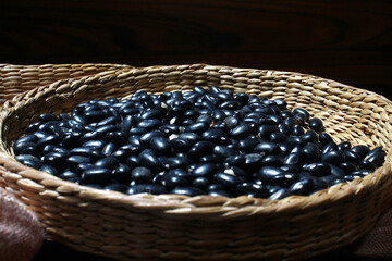 Black beans in the wicker basket. Brazilian beans.