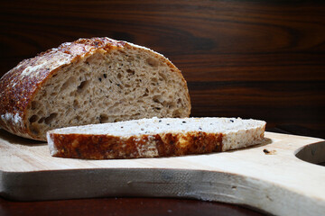 Bread with a slice on the cutting board. Brazilian breakfast.