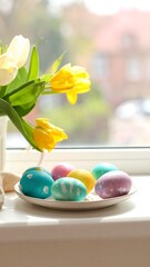 Easter eggs and tulips on a windowsill