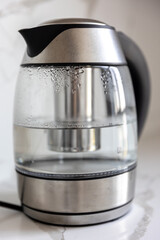 Glass electric kettle. Hot steam details. Modern kitchen