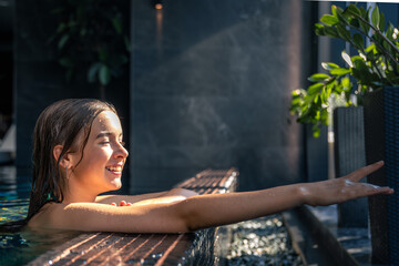 Sunny pause girl at the pool edge, reaching for plants. Soft relax, mindful.