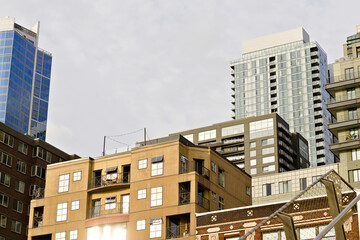 Modern downtown Seattle cityscape with a mix of residential apartments, highrise towers, and urban architecture under bright daylight.