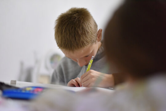 Brother and sister doing homework together at home