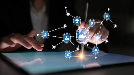A person interacts with a digital tablet showcasing an array of technology icons, emphasizing data visualization and modern communication in a business environment. Tessel