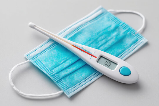 Thermometer on surgical mask for health safety - Powered by Adobe