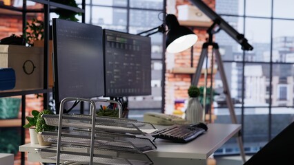 PC screens in innovative startup office showing programming languages used to build applications. Empty software development agency used for optimizing code on computers, handheld camera shot