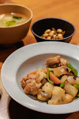 Japanese dinner with stir-fried chicken and vegetables, simmered beans, rice and miso soup
