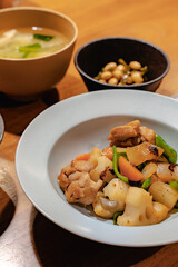 Japanese dinner with stir-fried chicken and vegetables, simmered beans, rice and miso soup
