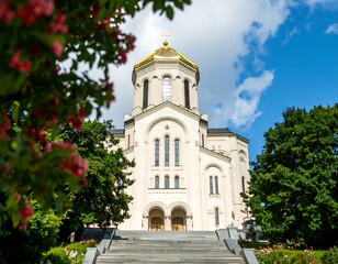 Fototapeta premium Ornate church facade with blooming shrubs