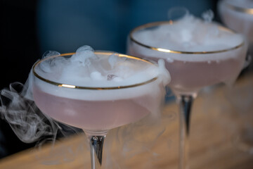 Elegant cocktails with dry ice create a foggy, mysterious aura, showcasing drinks in stylish...