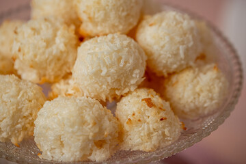 Delicious coconut macaroons arranged on a decorative glass plate, showcasing their fluffy texture and golden-brown edges, perfect for dessert lovers and culinary enthusiasts