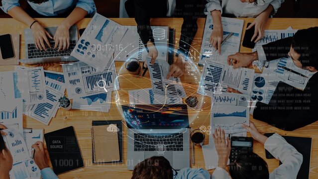 A dynamic business meeting scene displaying diverse professionals engaged in data analysis with charts and reports on the table, fostering collaboration and innovation. Raster - Powered by Adobe