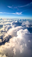 High-altitude view of fluffy white clouds against a vibrant blue sky (1)
