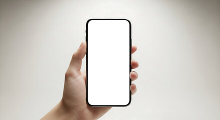 Hand holding smartphone mockup with blank white screen for app presentation. Studio shot of modern device in human hand against neutral background