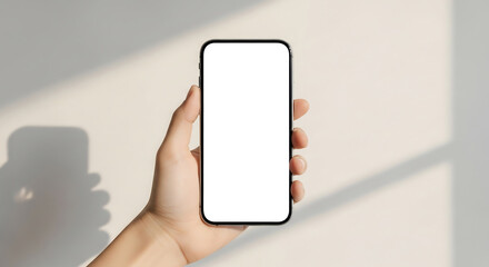 Hand holding smartphone with blank screen. Modern minimalist style, soft sunlight, clean background