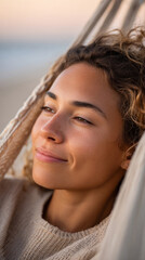 Relaxed young woman enjoying tranquility in a hammock outdoors