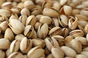 Many tasty unpeeled pistachios top view flat lay background pattern