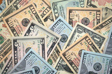 Big amount of different dollar bills close up. Hundred fifty twenty ten and five dollar banknotes