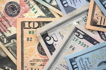 Big amount of different dollar bills close up. Hundred fifty twenty ten and five dollar banknotes