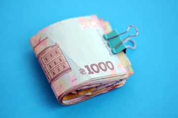 Ukrainian money bills on light blue paper background