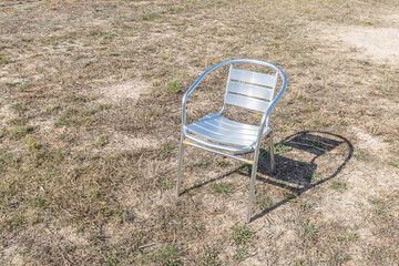 Metallic white chair on the gray background